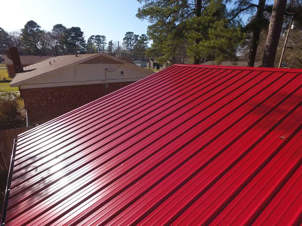 new red standing seam metal roofing in Nashville, AR installed by Hostetler roofing